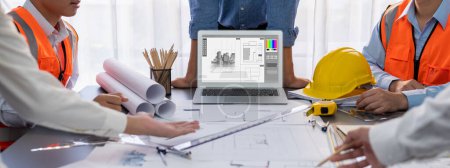 Photo for Engineer and architect working together brainstorming and designing blueprint using laptop working with architectural software for precise digital interior or structure design. Insight - Royalty Free Image