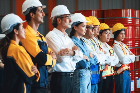 Photo for Confident and smiling lineup of factory worker, engineer, manager and foreman stand on-site within heavy industrial manufacturing factory with sense of teamwork and determination. Exemplifying - Royalty Free Image