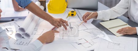 Photo for Architect or engineer working on building blueprint, contractor designing and drawing blueprint layout with tool for construction project. Civil engineer and architecture design concept. Insight - Royalty Free Image