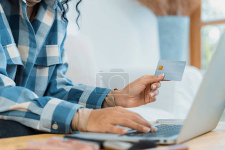 Photo for Close up credit card using for online payment, banking and shopping on the internet network with laptop computer showing credit card technology for online secured wallet top up and crucial purchase - Royalty Free Image