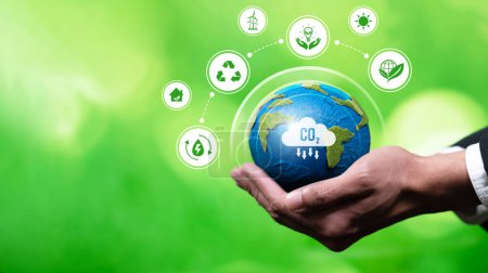 Photo for Businessmans hand holding Earth globe symbolize corporate commitment to ESG or CSR to reduce carbon emission and adopting eco-friendly clean business minimizing environmental impact.Panorama Reliance - Royalty Free Image