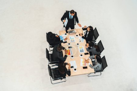 Photo for Business people group meeting shot from top view in office . Profession businesswomen, businessmen and office workers working in team conference with project planning document on meeting table . Jivy - Royalty Free Image