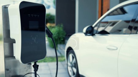 Photo for Home charging station provides an eco-friendly sustainable power supply for EV cars. Progressive concept for future green energy storage for electric vehicles. - Royalty Free Image