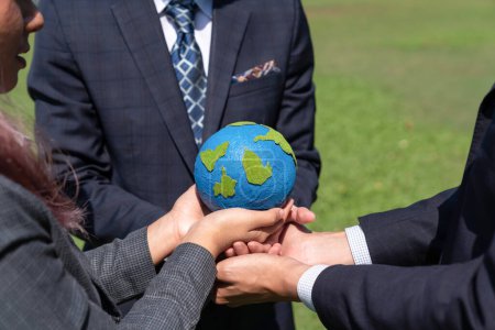 Photo for Group of business people hold planet Earth globe together as Earth day concept. Mission to save Earth by business commitment to environment friendly methods and sustainable practices. Gyre - Royalty Free Image