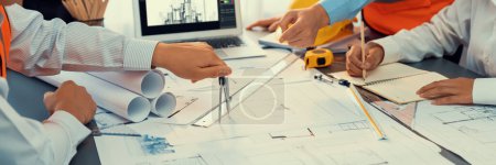 Photo for Architect or engineer working on building blueprint, contractor designing and drawing blueprint layout with tool for construction project. Civil engineer and architecture design concept. Insight - Royalty Free Image