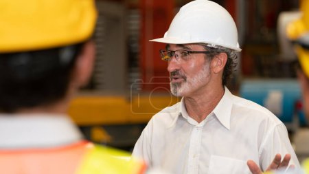 Photo for Collective factory worker and engineer gather for meeting with factory executive or manager, discussing plan and industry training program on-site work heavy industrial steel workshop. Exemplifying - Royalty Free Image