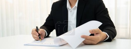 Photo for Business executive signing contract agreement document on the bale with the help from company attorney or lawyer service in law firm office. Business investing and finalizing legal processing. Shrewd - Royalty Free Image