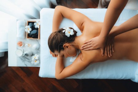 Photo for Panorama top view woman customer enjoying relaxing anti-stress spa massage and pampering with beauty skin recreation leisure in day light ambient salon spa at luxury resort or hotel. Quiescent - Royalty Free Image
