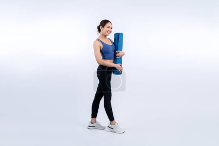 Photo for Young attractive asian woman portrait in sportswear with exercising mat. Healthy exercise and workout routine lifestyle concept. Studio shot isolated background. Vigorous - Royalty Free Image