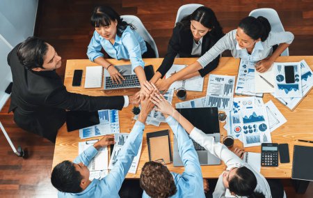 Photo for Multiracial business people make synergy hand stack together in meeting room as cooperation or team building for corporate employee in workplace. Top view. Meticulous - Royalty Free Image