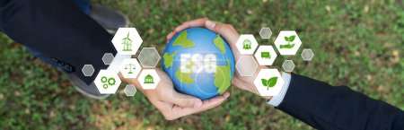 Photo for Two businessmens hand holding planet Earth together symbolize ESG business partnership invest on environmental protection by renewable energy for carbon reduction for greener Earth. Panorama Reliance - Royalty Free Image