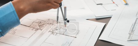 Photo for Architect or engineer working on building blueprint, contractor designing and drawing blueprint layout for building construction project. Civil engineer and architectural design concept. Insight - Royalty Free Image