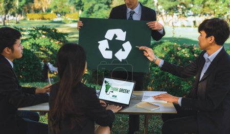 Photo for Group of businesspeople meeting at outdoor office in the nature planning and brainstorming on recycle strategy for greener environment by reducing and reusing recyclable waste. Gyre - Royalty Free Image