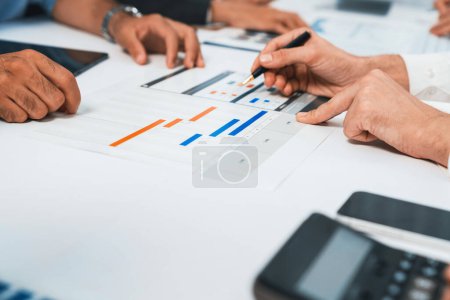 Photo for Analyst team utilizing BI Fintech to analyze financial data at table in meeting room. Businesspeople analyzing BI dashboard power on paper for business insight and strategic marketing planning.Prudent - Royalty Free Image