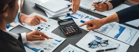 Photo for Auditor and accountant team working in office, analyze financial data and accounting record with calculator. Accounting company provide finance and taxation planning for profitable cash flow. Insight - Royalty Free Image