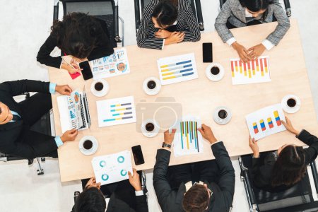 Photo for Business people group meeting shot from top view in office . Profession businesswomen, businessmen and office workers working in team conference with project planning document on meeting table . Jivy - Royalty Free Image