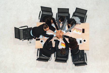 Photo for Happy business people celebrate teamwork success together with joy at office table shot from top view . Young businessman and businesswoman workers express cheerful victory show unity support . Jivy - Royalty Free Image