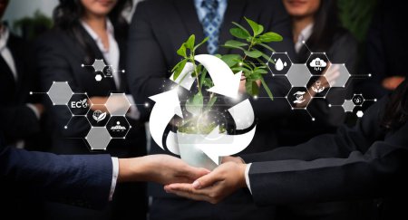 Téléchargez les photos : Le partenariat commercial qui nourrit ou cultive des plantes avec l'icône du recyclage symbolise la protection durable de l'environnement ESG grâce à la technologie de recyclage écologique et à la gestion des ressources recyclables. Dépendance - en image libre de droit