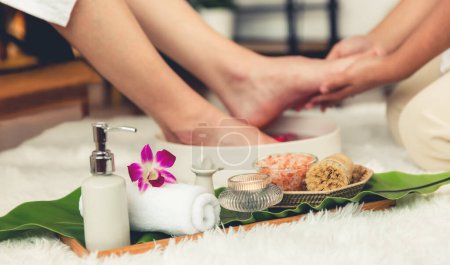 Photo for Man indulges in blissful foot massage at luxurious spa salon while masseur give reflexology therapy in gentle day light ambiance resort or hotel foot spa. Quiescent - Royalty Free Image