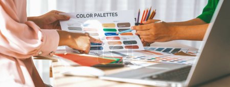 Photo for A cropped image of professional interior designer discuss the color material with her colleagues by comparing with color swatches and color palette document. Creative design concept. Variegated. - Royalty Free Image