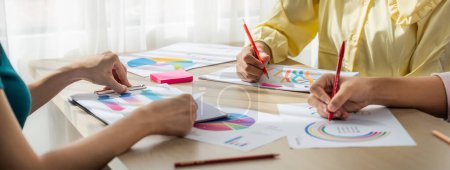 Photo for Startup company employee working together, analyzing BI dashboard paper on financial data report and planning strategic marketing for business success in panorama banner. Synergic - Royalty Free Image