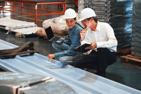 Photo for Metalwork manufacturing factory manager inspect newly manufactured metal or steel sheets and frame in factory. Inspection and quality control process ensure highest quality product. Exemplifying - Royalty Free Image