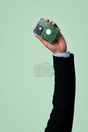 Photo for Businessmans hand holding electronic waste on isolated background. Eco-business recycle waste policy in corporate responsibility. Reuse, reduce and recycle for sustainability environment. Quaint - Royalty Free Image