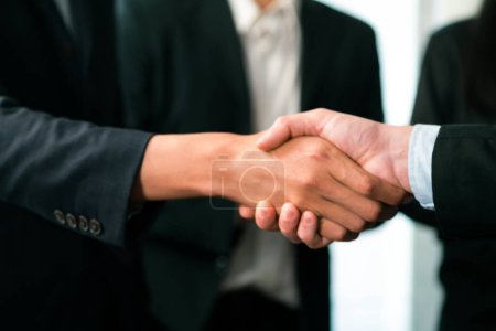 Photo for Asian business people shake hand after made successful agreement deal in meeting room, professional hand shaking with applause in corporate company. Quaint - Royalty Free Image