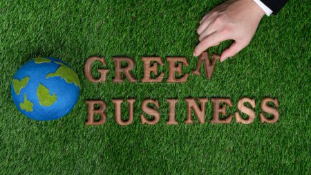 Photo for Businessmans hand arrange message in Green Business as concept of corporate effort to commitment to CSR or corporate social responsible concept for environmentally sustainable. Gyre - Royalty Free Image