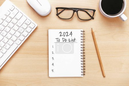 Photo for 2024 Happy New Year Resolution Goal List and Plans Setting - Business office desk with notebook written about plan listing of new year goals and resolutions setting. Change and bliss concept. - Royalty Free Image