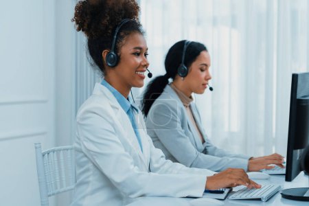 Photo for Business people wearing headset working in office to support remote customer or colleague. Call center, telemarketing, customer support agent provide service on telephone video conference call crucial - Royalty Free Image