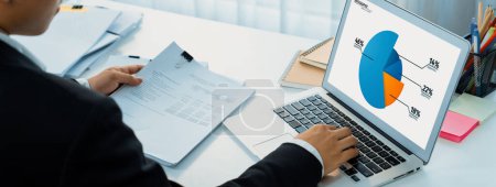 Photo for Business intelligence analyst use BI software on laptop to analyze financial data dashboard. Business technology empower corporate executive to make analytic strategic decision in panorama. Shrewd - Royalty Free Image