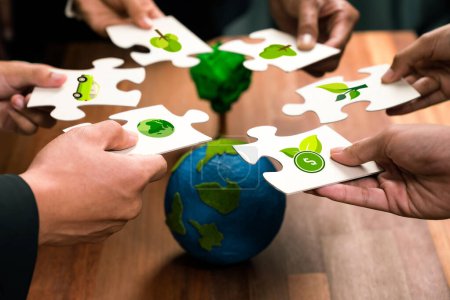 Photo for Cohesive group of business people holding eco icon jigsaw puzzle pieces around globe Earth as eco corporate responsibility for community and sustainable solution for greener Earth. Quaint - Royalty Free Image