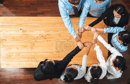 Photo for Multicultural business people holding hand together in circle. Unity teamwork in office business workplace. Diverse ethnic office worker engaged in team building. Panorama top view. Meticulous - Royalty Free Image