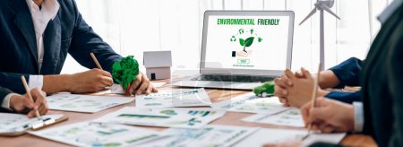 Téléchargez les photos : Business people in green corporate company planning eco-friendly and environmental conservative to reduce CO2 and implement net zero policy in meeting room with eco idea on laptop screen. Des pionniers - en image libre de droit