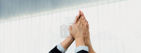 Photo for Office worker team stacking hand together symbolize successful group of business partnership and strong collective unity teamwork in community workplace in panoramic banner. Shrewd - Royalty Free Image