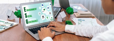 Photo for ESG environmental social governance display on laptop on eco-friendly company with businessman planning on environmental protection initiative for clean and sustainable future ecology. Trailblazing - Royalty Free Image