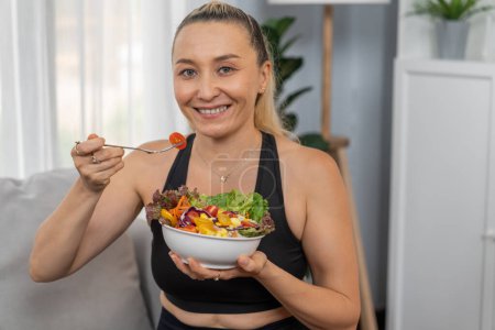 Photo for Healthy senior woman in sportswear holding a bowl of fruit and vegetable. Vegan lifestyle and healthy cuisine nutrition for fitness body physique concept. Clout - Royalty Free Image