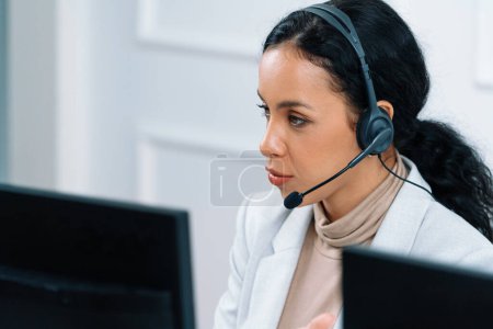 Photo for African American businesswoman wearing headset working in office to support remote crucial customer or colleague. Call center, telemarketing, customer support agent provide service on video call. - Royalty Free Image