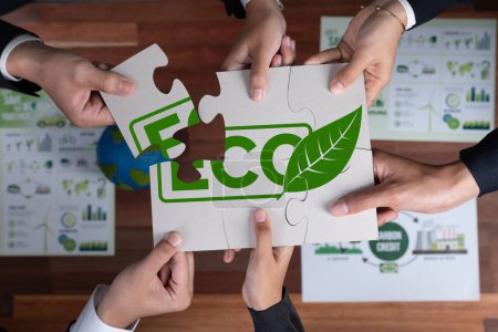 Photo for Top view cohesive group of business people forming jigsaw puzzle pieces in environmental awareness symbol as eco corporate responsibility as sustainable solution for greener Earth. Quaint - Royalty Free Image