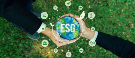 Two businessmens hand holding planet Earth together symbolize ESG business partnership invest on environmental protection by renewable energy for carbon reduction for greener Earth. Panorama Reliance