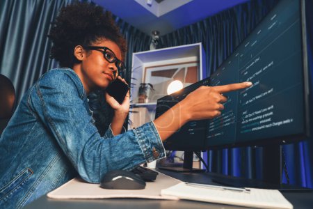 Photo for Young African American IT developer concentrating on monitor screen laptop with codding program in data of application and website, Concept of creating innovative html updated version. Tastemaker. - Royalty Free Image