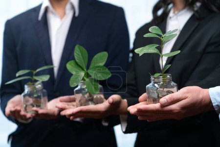 Photo for Business people holding money savings jar filled with coins and growing plant for sustainable financial planning for retirement or eco subsidy investment for environment protection. Quaint - Royalty Free Image