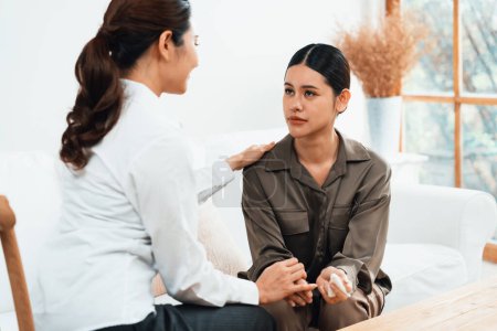 Photo for Sad PTSD woman patient in uttermost therapy for mental health with psychologist, depression or grief after life failure. Frustrated trauma young woman talking to a psychologist about emotion in clinic - Royalty Free Image