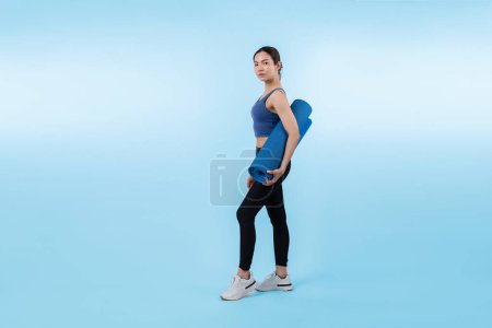 Photo for Young attractive asian woman portrait in sportswear with exercising mat. Healthy exercise and workout routine lifestyle concept. Studio shot isolated background. Vigorous - Royalty Free Image