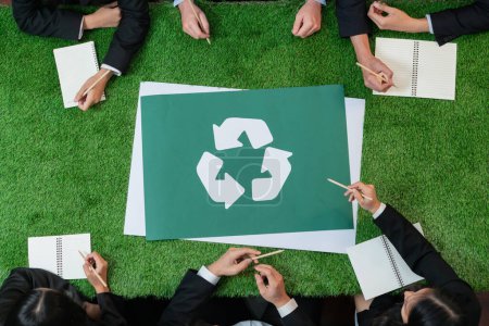 Photo for Top view panorama banner recycle icon on meeting table in office with business people planning eco business investment on waste management as recycle reduce reuse concept for clean ecosystem. Quaint - Royalty Free Image