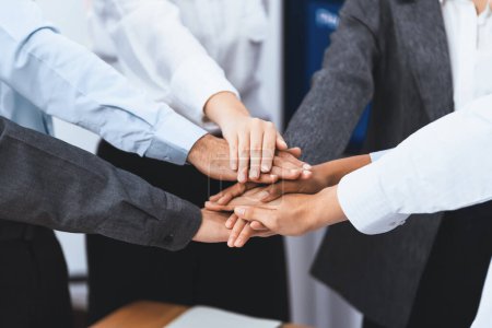Photo for Multiracial office workers hand stack shows solidarity, teamwork and trust in diverse community. Businesspeople unite for business success through synergy and collaboration by hand stacking. Concord - Royalty Free Image
