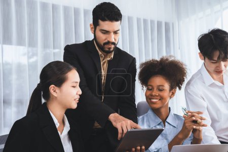 Photo for Happy diverse business people work together, discussing in corporate office. Professional and diversity teamwork discuss business plan on desk with laptop. Modern multicultural office worker. Concord - Royalty Free Image
