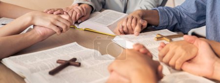 Photo for Cropped image of diversity people hand praying together at wooden church on bible book while hold hand together with believe. Concept of hope, religion, faith, god blessing concept. Burgeoning. - Royalty Free Image