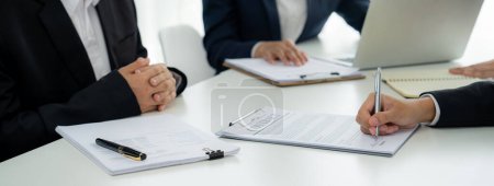 Photo for Two business executive in boardroom discuss term and company merging agreement, review corporate contract document as business partnership and cooperation with acquisition and merger concept. Shrewd - Royalty Free Image